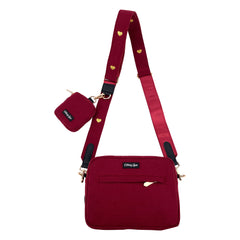 Red crossbody bag with matching pouch on a white background