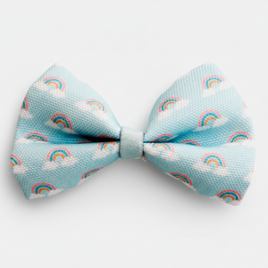 Light blue bow tie with rainbow and cloud pattern on a white background