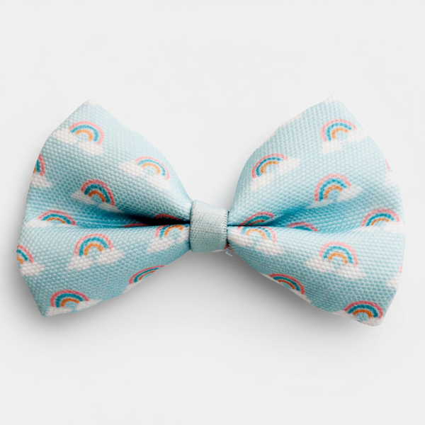 Light blue bow tie with rainbow and cloud pattern on a white background